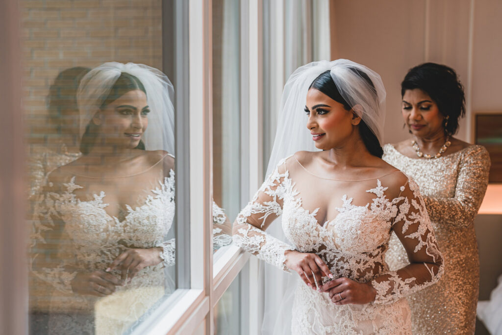 A mother fastening a brides dress on her wedding day at The Pearle Hotel
