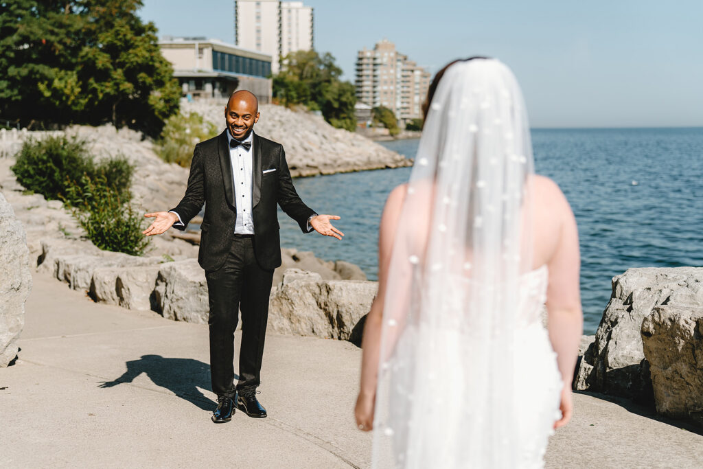 A couple during their first look on the shores of lake ontario at The Pearle Hotel