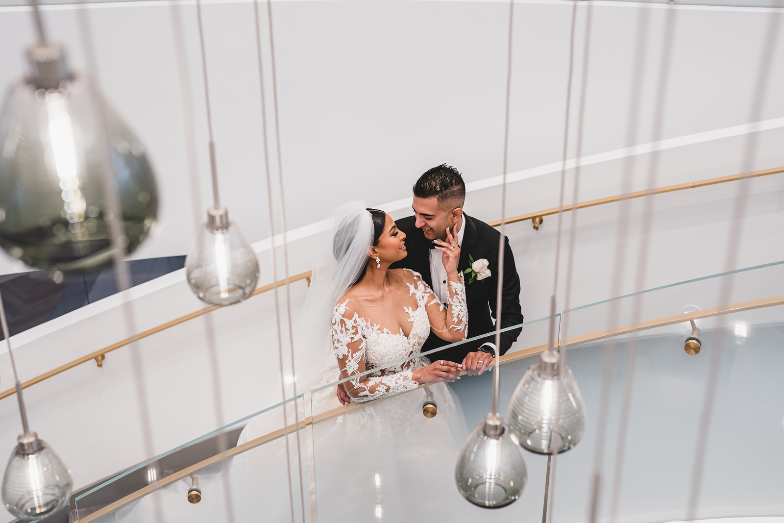 A portrait of a couple on the stairs at The Pearle Hotel