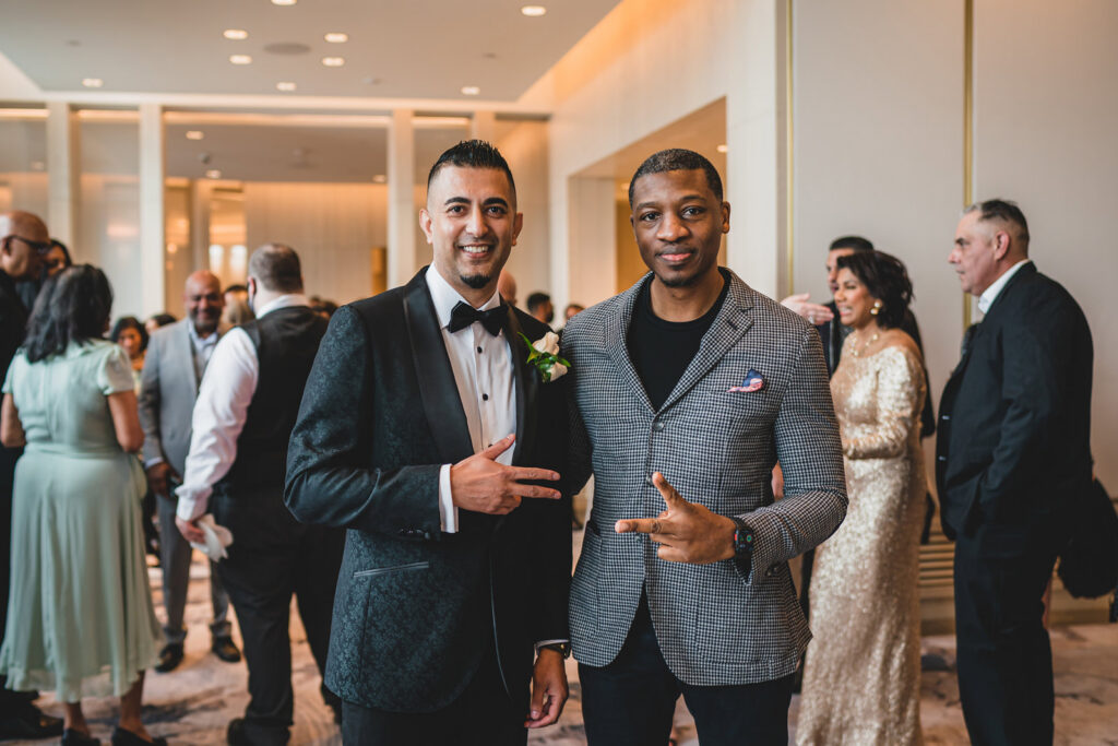 A groom and his friend during cocktail hour at The Pearle Hotel