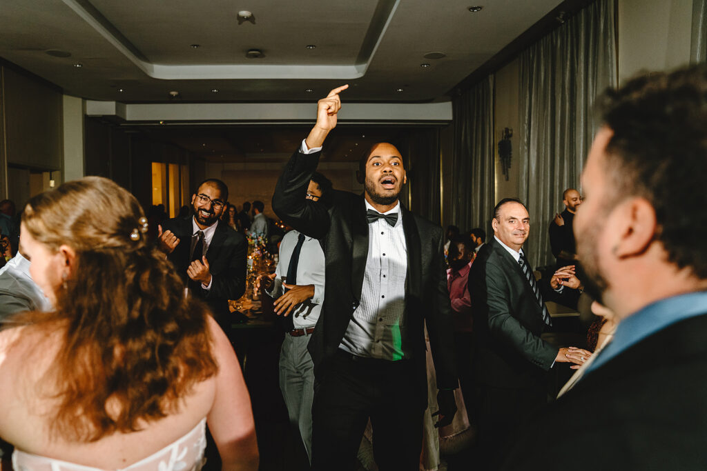 A groom on the dance floor at his wedding at The Pearle Hotel