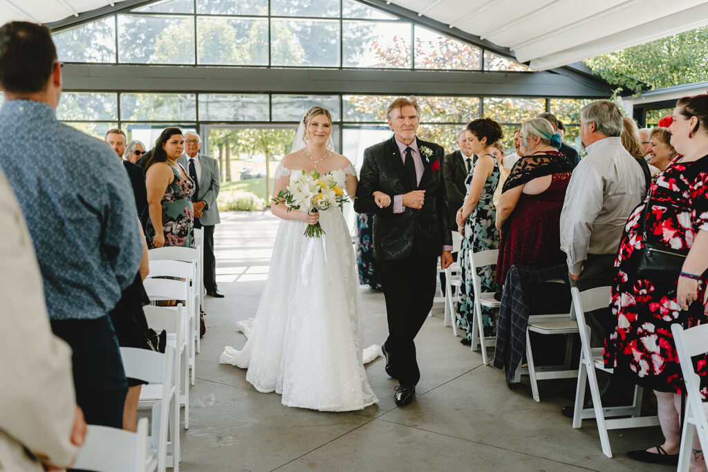 A Bride and her Dad walking down the aisle