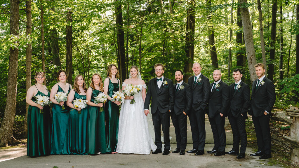 a large bridal party at in the woods at whistle bear in Cambridge