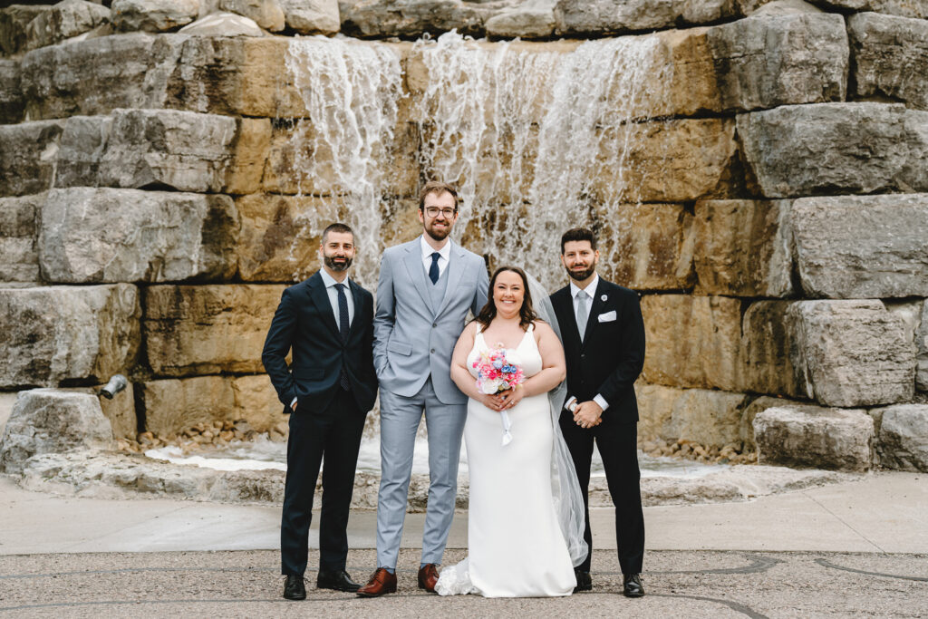 Family portraits in front of the waterfall at whistle bear