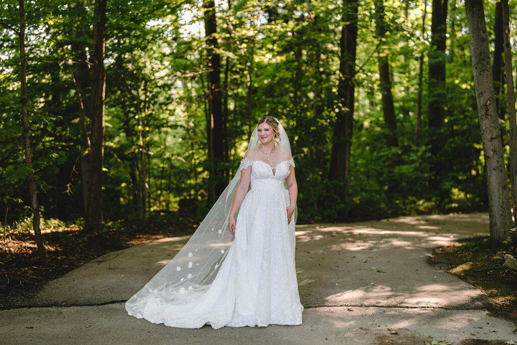 A bride in the tree lined landscape at whistle bear