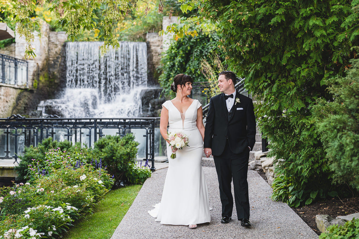 Newlyweds in the grounds of ancaster mill by the waterfall