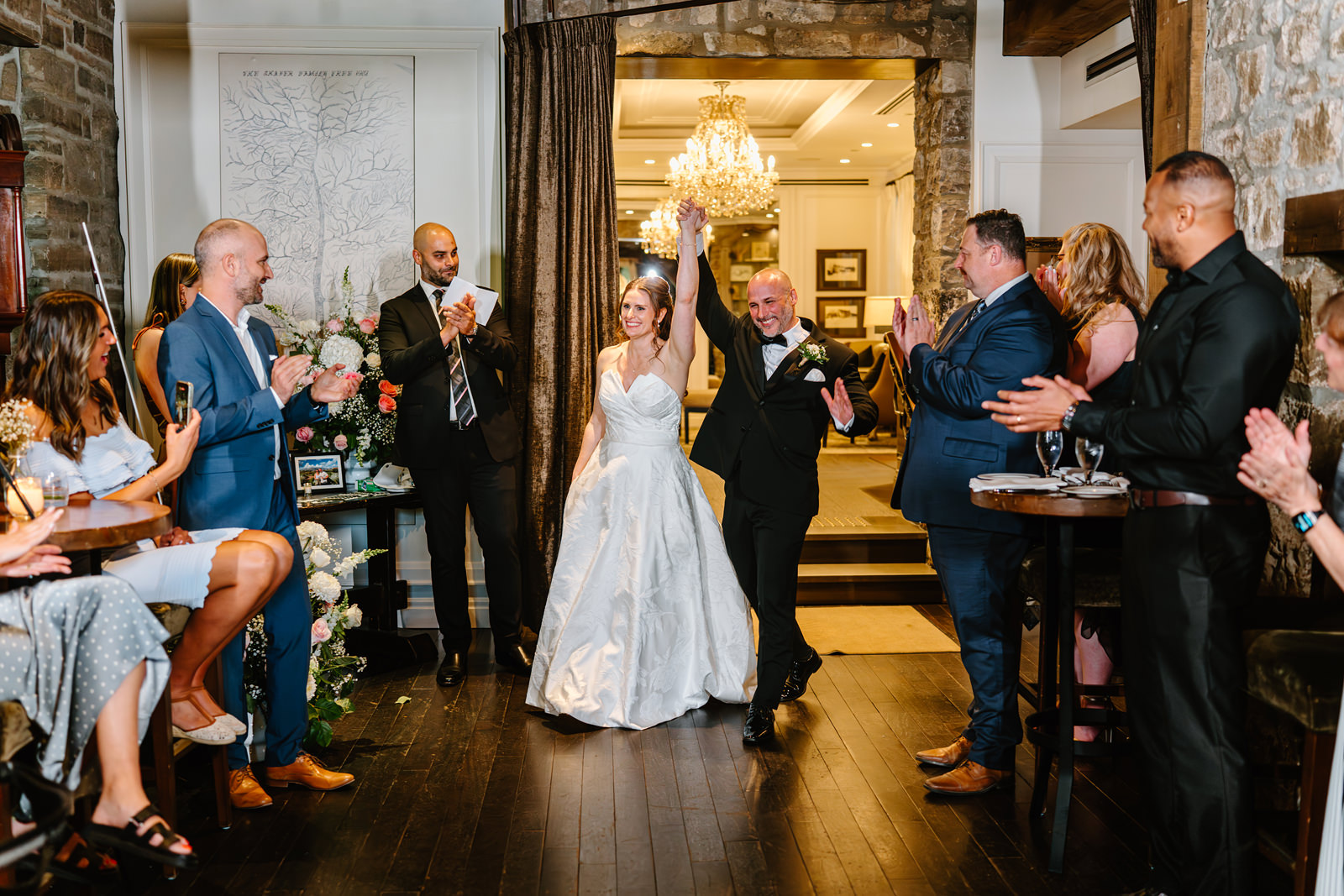 Newlyweds walking into their wedding reception at Ancaster Mill