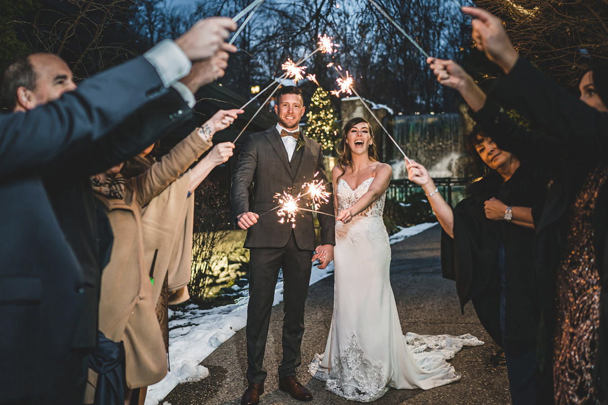 Newlyweds and guests enjoy playing with sparklers at Ancaster Mill