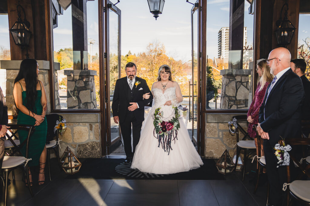 A bride walking down the aisle at Cambridge Mill