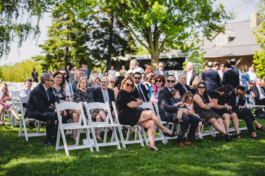 Guests sitting for an outdoor ceremony at The Earth to Table Farm