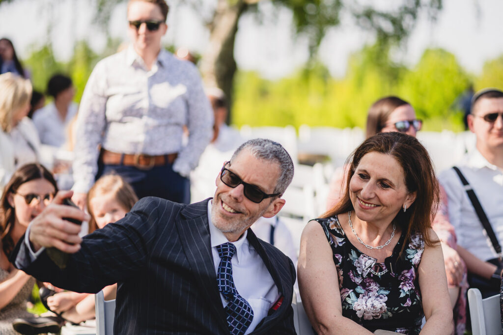 Wedding guests taking selfies at The Earth to Table Farm wedding venue