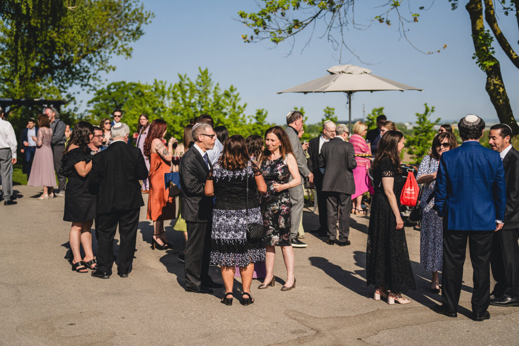 Guests enjoying cocktail hour outside at The Earth to Table Farm wedding venue