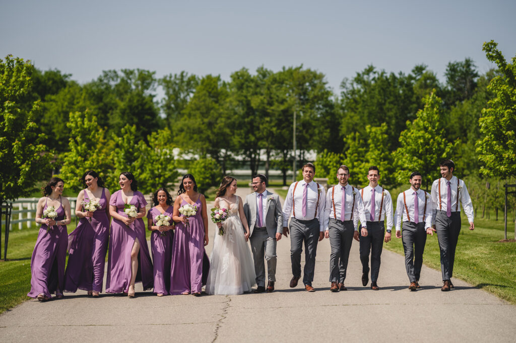 A bridal party walking together at The Earth to Table Farm wedding venue