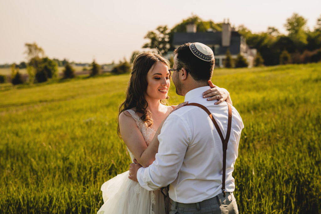 Newlyweds enjoying golden hour photos at The Earth to Table Farm wedding venue
