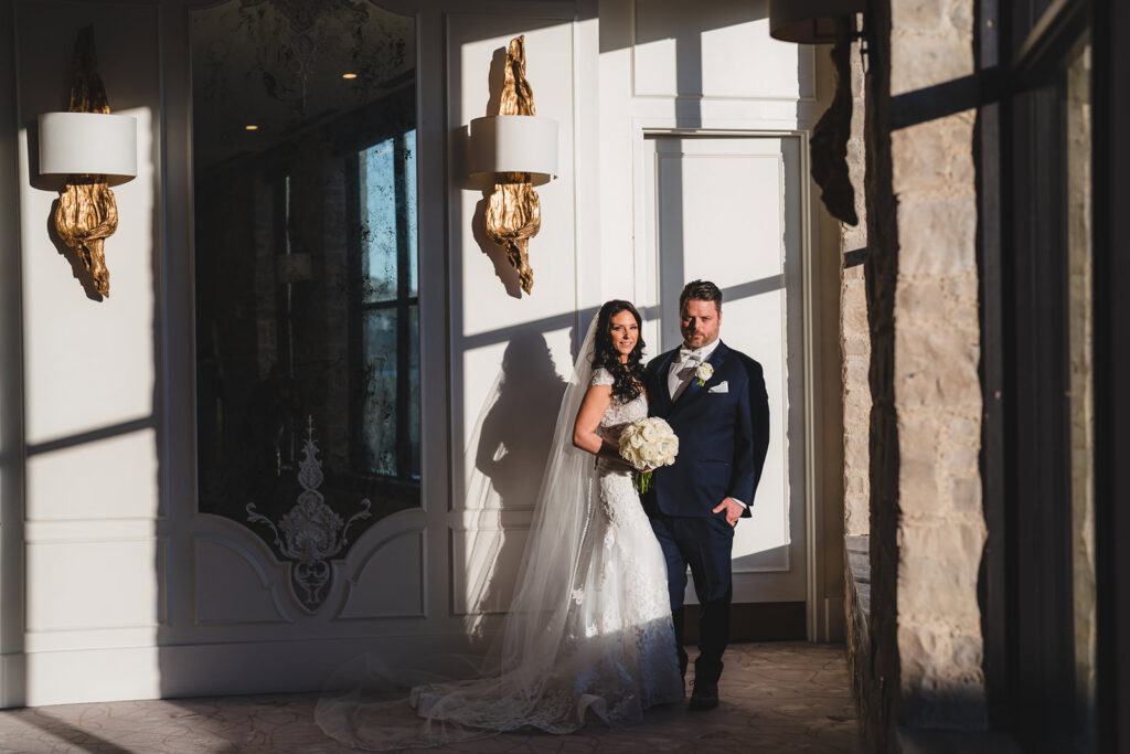 Newlyweds posing indoors at Elora Mill, Ontario