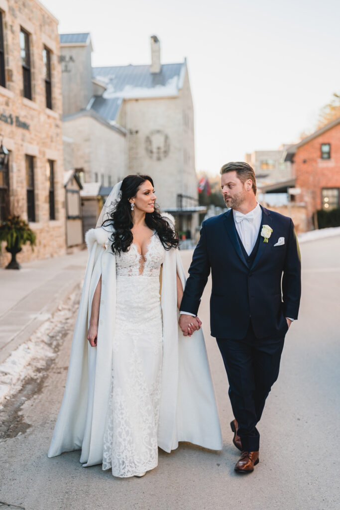 Newlyweds walking in front of Elora Mill, Elora