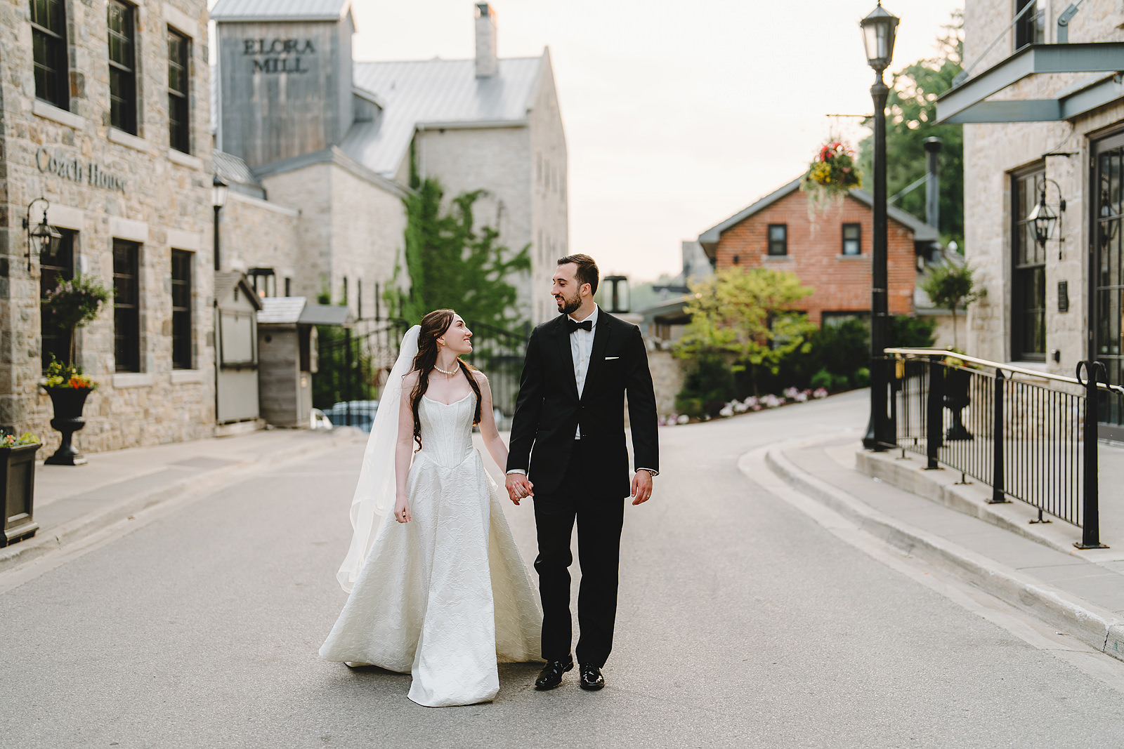 Newlyweds walking down the street after getting married at Elora Mill