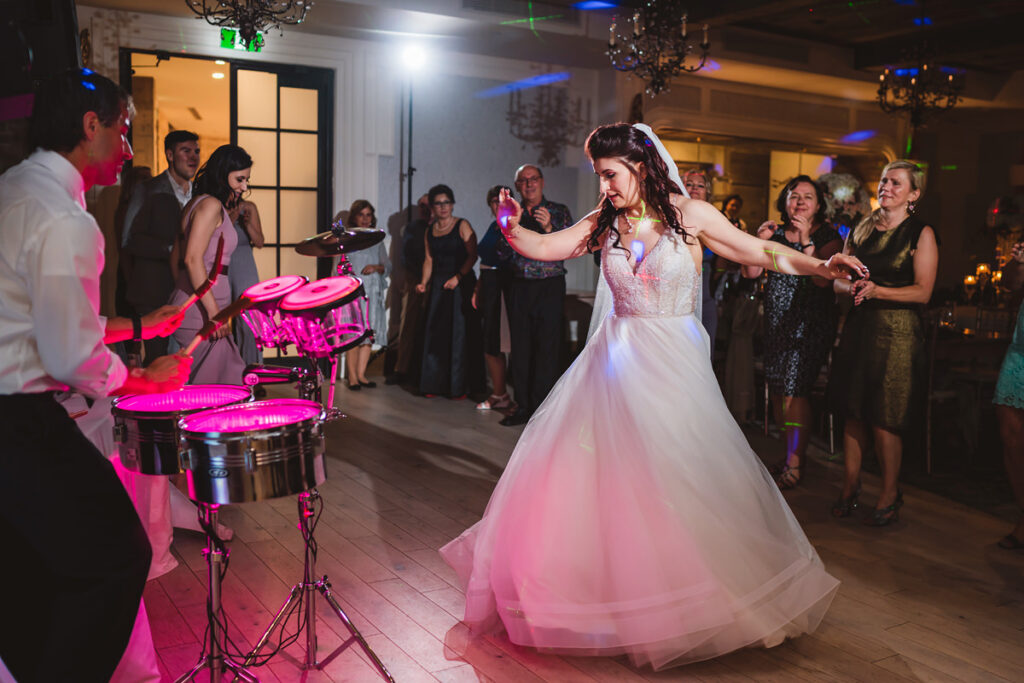 A bride on the dance floor at her wedding at Elora Mill
