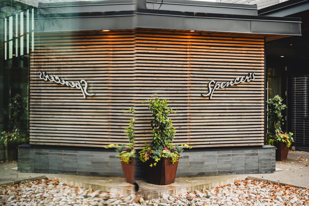 A mirrored exterior photo of the entrance to Spencers at the Waterfront
