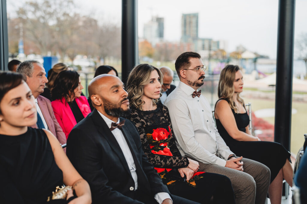 Wedding guests watching the couple get married at Spencer's at the Waterfront