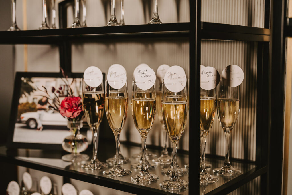 Champagne with seat numbers at a Spencer's at the Waterfront Wedding