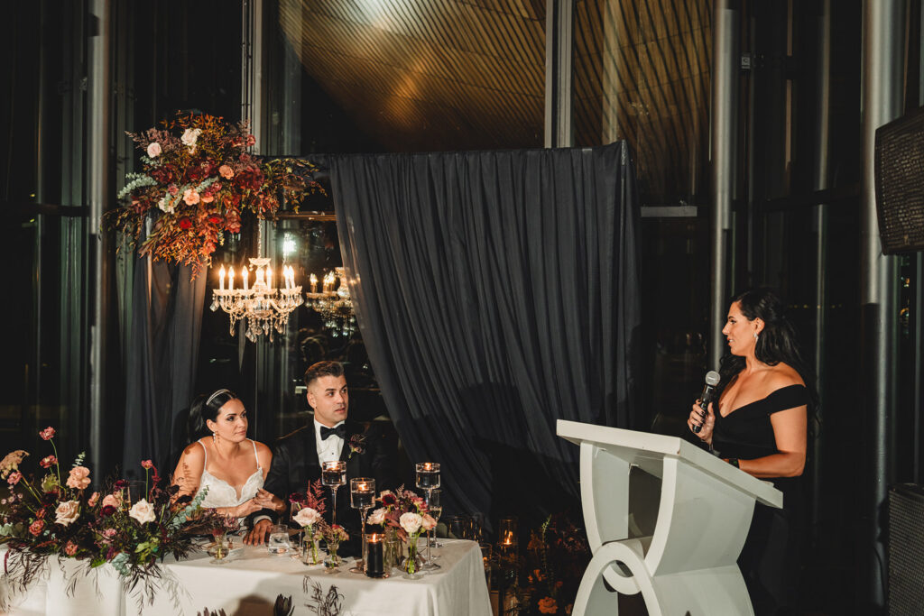 Newlyweds watch on during speeches at Spencer's at the Waterfront